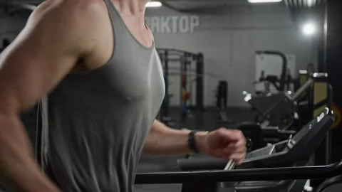 Fit Man Running on Treadmill during Intense Cardio Workout in Gym Stock Footage 339888411