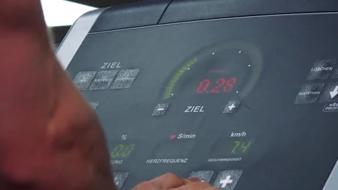 A fit man sets speed on a treadmill screen in a gym - closeup Vídeo Stock 85302124