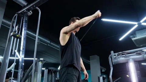 Fit man training body with crossover machine. Exercise for shoulders. Strength Video stock 279924486