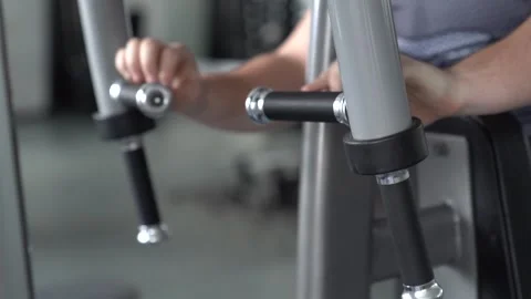 Fit man training on machine at gym Stock Footage 252140312