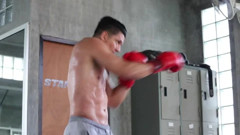 Fit man training punching air in gym. workout boxing exercise Stock Footage 246101798