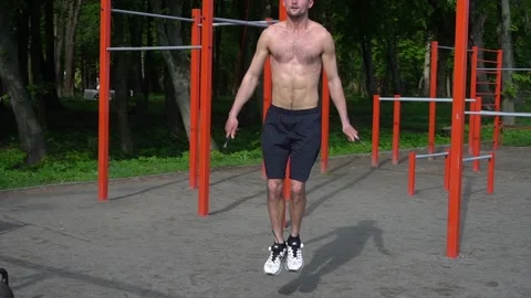 Fit man training on skipping rope on outdoor workout. Video stock 130818565