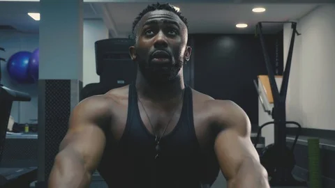 Fit man using rowing machine at the gym,. slow motion intense Stock Footage 89577515