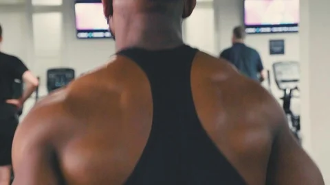 Fit man using a treadmill at the gym, Slow motion shot of his back Stock Footage 89577417