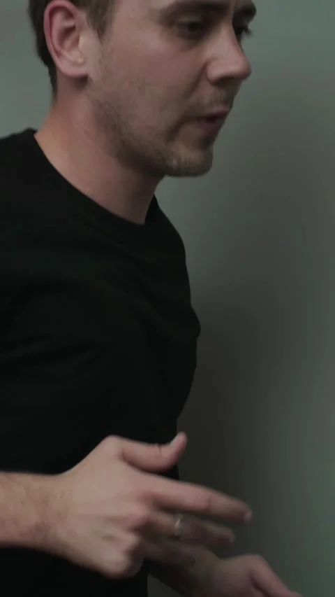 A fit man warms up by running on a treadmill before starting his main workout Stock Footage 305570089