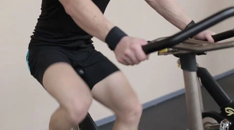 Fit man working out on exercise bike at the gym Stock Footage 62561657