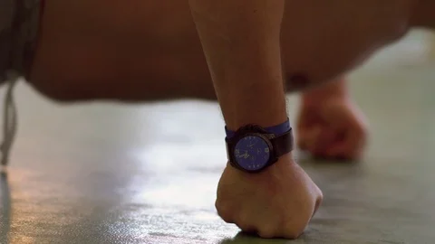 Fit middle-aged man doing press-ups in a gym Stock Footage 121451615