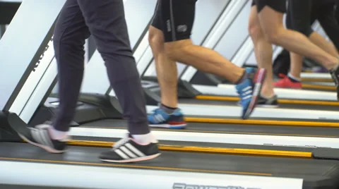 Fit people jogging on treadmills at the gym Stock Footage 59882950