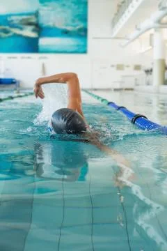 Fit swimmer doing the front stroke in the swimming pool Stock Photos