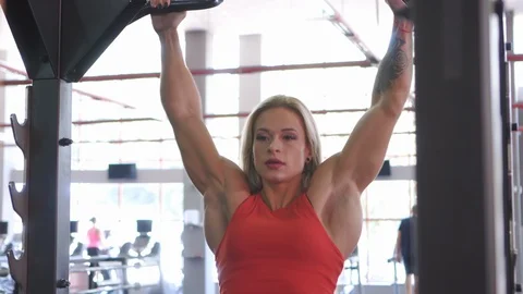 Fit woman doing pull ups exercise Stock Footage 97489449