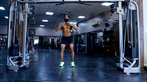 Fit Young Beard Man Doing Jumping Squat Exercise in Gym Topless Video stock 149484128