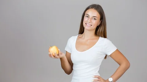 Fit young brunette with apple. Stock Footage 96299765