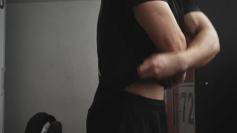 Fit young man changing clothes Video stock 117911214