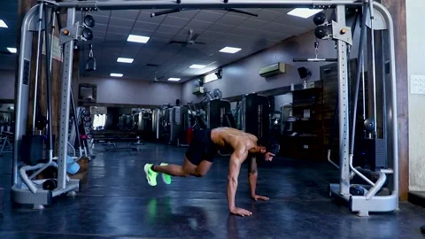 Fit young man  doing Doing Abs  workout  Mountain Climbing at a gym Stock Footage 149484126