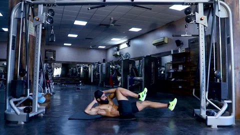 Fit young man  doing Doing Abs  workout at a gym Video stock 149484129