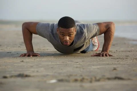 Fit young man doing push ups outdoors 库存照片