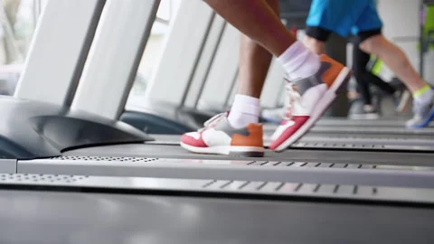 Fit young man exercising on a running machine at the gym Stock Footage 270100639