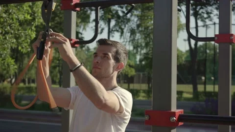 Fit young man preparing for exercising with gym equipment outdoor Stock Footage 146305724