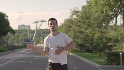 Fit young man preparing for workout doing stretching exercise outdoor Stock Footage 146307314