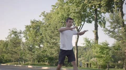 Fit young man preparing for workout doing stretching exercise outdoor Stock Footage 146308072