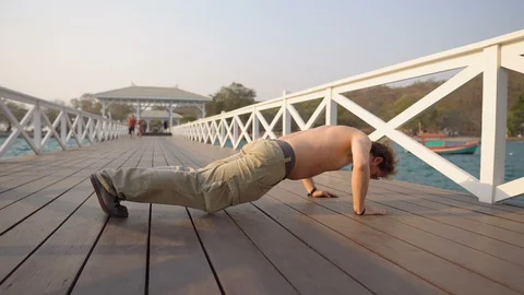 Fit Young Shirtless Man Doing Pushups Workout Outdoors in Public on Ocean Pier Stock Footage 126261007