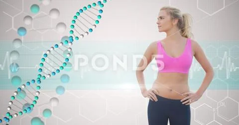 Fit young woman with hands on hips looking at DNA structure Stock Photos