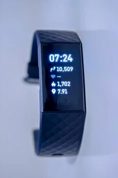 A Fitbit Charge 3 on a grey background. Stock Photos