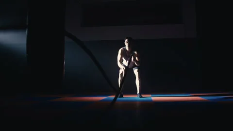 Fitness athlete training using battle ropes intense workout Stock Footage 271182238