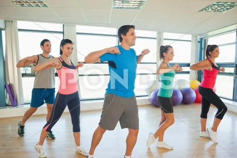 Fitness class and instructor doing pilates exercise Stock Photos