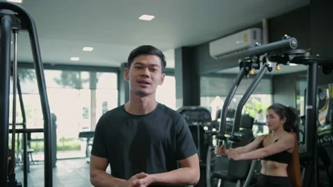 Fitness concept of 4k Resolution. Asian male trainer gives an interview at th Stock Footage 148778341