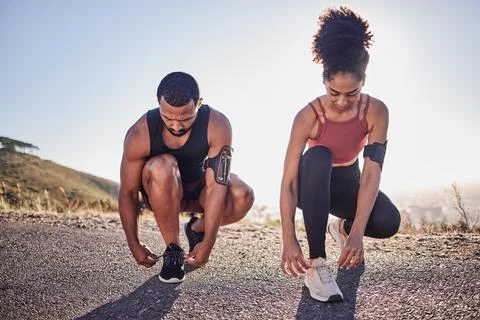 Fitness couple, running shoes and exercise on a road outdoor for cardio workout Stock Photos