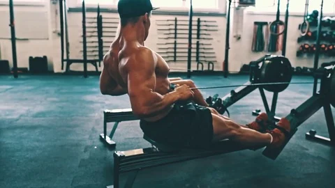 Fitness couple training on row ergometer machine at cross gym Stock Footage 79392638