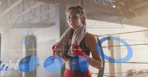 Fitness data visualization image over woman in gym with towel and boxing gloves Foto stock