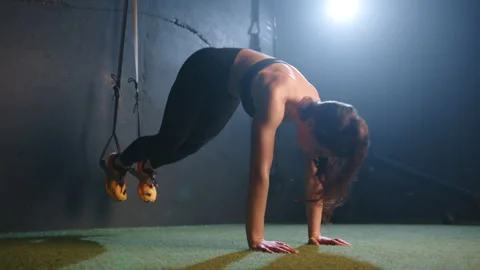 Fitness Devotee Engages in Intensive Core-Strengthening TRX Exercise at Urban Stock Footage 264534189