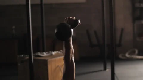 Fitness enthusiast performs strength exercise with weight ball on gym mat Stock Footage 312763353
