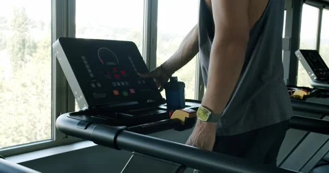 Fitness Enthusiast Using Treadmill in Modern Gym Overlooking Nature Stock Footage 274470403