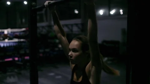Fitness girl doing pull ups at the gym. Stock Footage 70470709