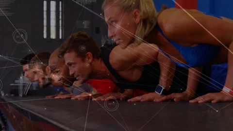 Fitness group performing push-ups on gym floor, showing floating biometric data 動画素材 327280731