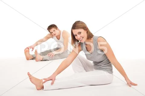 Fitness - healthy couple stretching after training on white Stock Photos