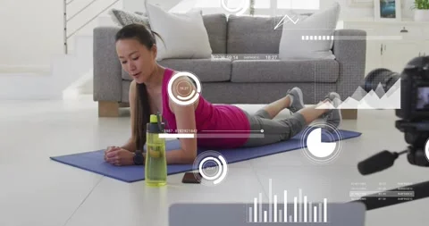 Fitness instructor holding plank, triggered by timer, checking phone and Stock Footage 317833863