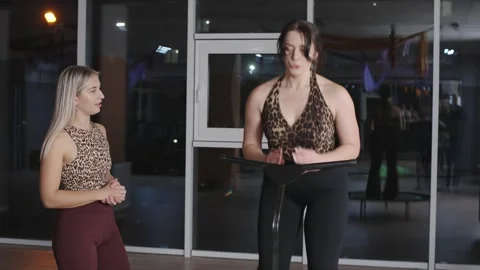 Fitness instructors demonstrate effective stretching techniques in a modern gym Stock-Footage 321752043