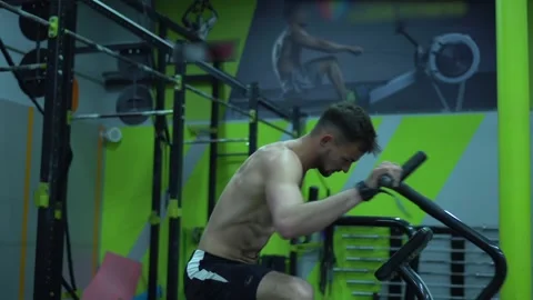 Fitness man athlete training using exercise bike intense cardio workout Stock Footage 132724141