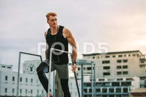 Fitness man climbing rooftop stairs Stock Photos