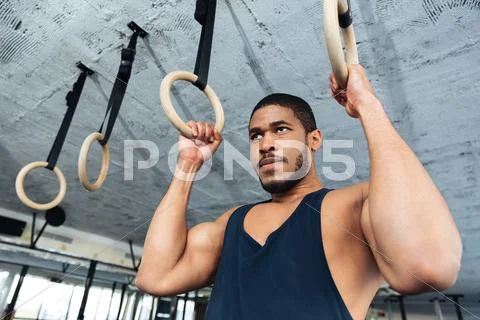 Fitness man doing dipping exercise using rings Stock Photos