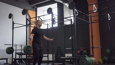 Fitness man doing double jumps rope workout in gym Stock Footage 88692479