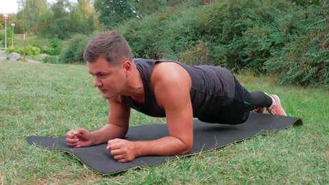 Fitness man doing plank exercise outdoor. Handsome athlete muscle concentration Stock Footage 146359970