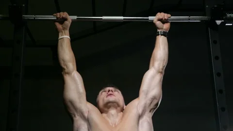 Fitness man doing pull-ups exercises in gym Video stock 144556906