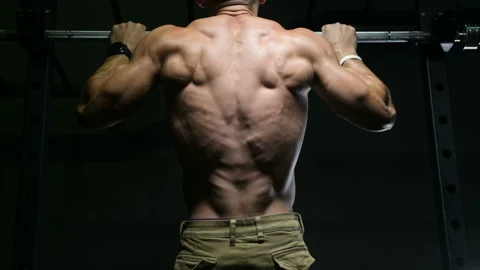 Fitness man doing pull-ups exercises in gym Stock-Footage 144556972