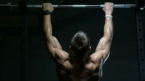 Fitness man doing pull-ups exercises in gym Video stock 144560130