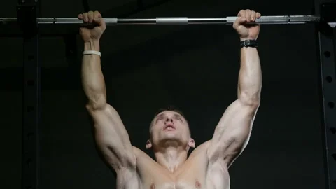 Fitness man doing pull-ups exercises in gym Video stock 144560276